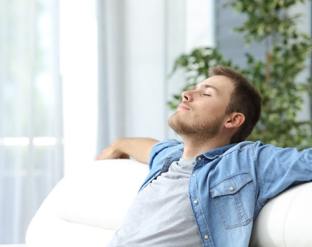 Man resting on a couch at home