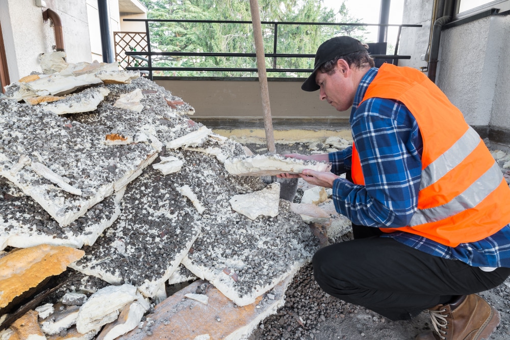 Technician examining old insulation