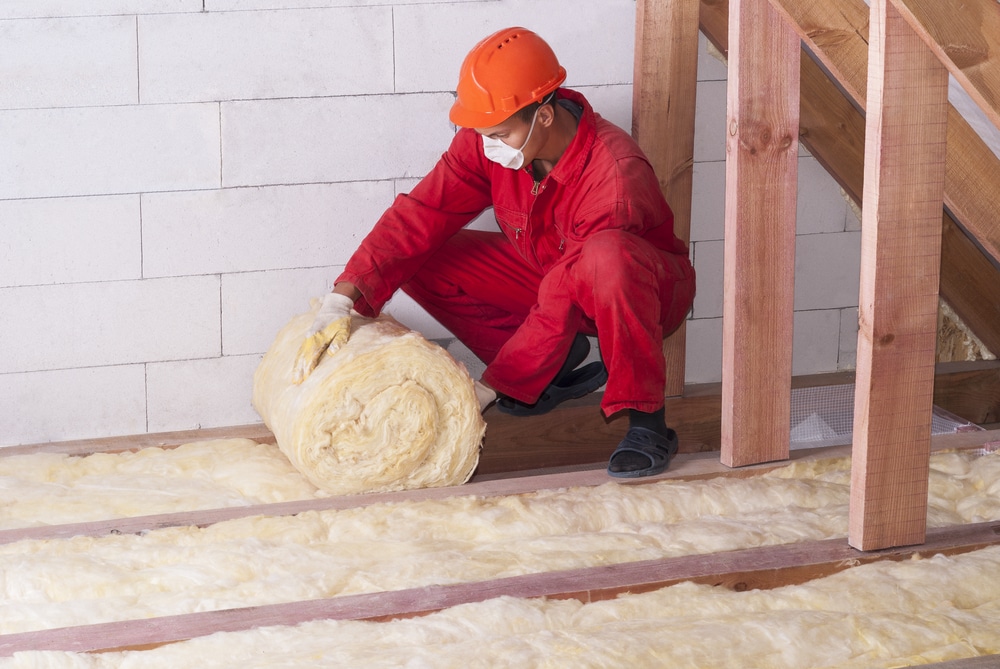 Technician installing insulation