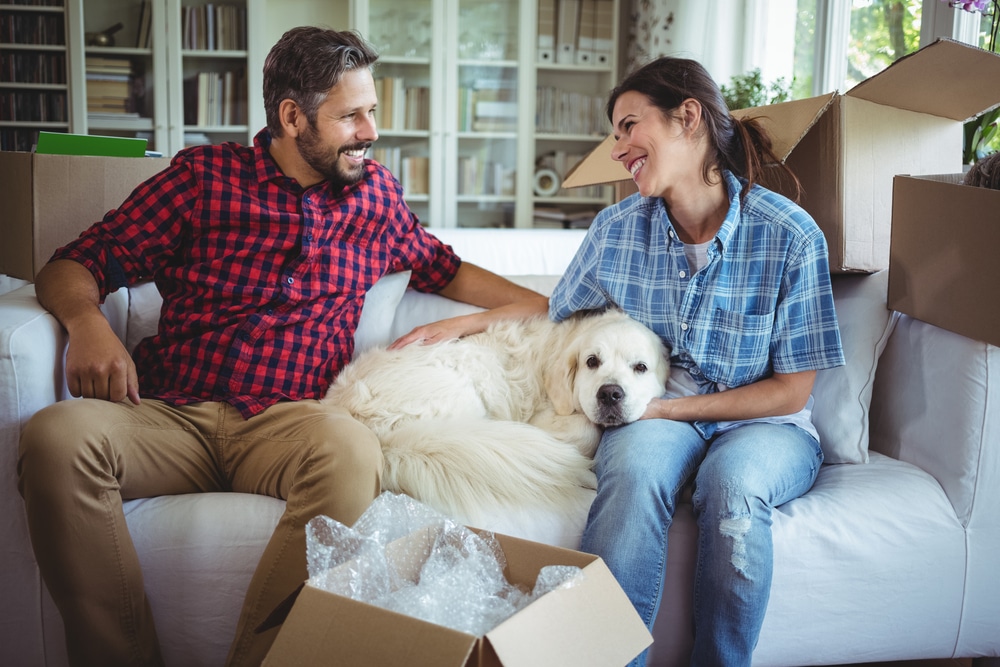 Homeowners with dog on couch