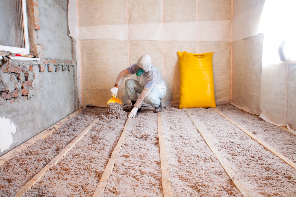 Technician installing insulation